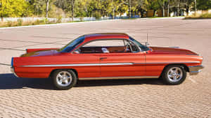 Classic Red Pontiac Ventura Parked Wallpaper