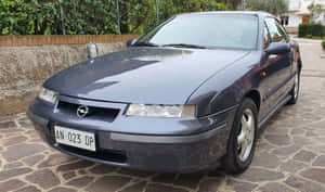 Classically Sleek, Vintage Opel Calibra On Open Road Wallpaper