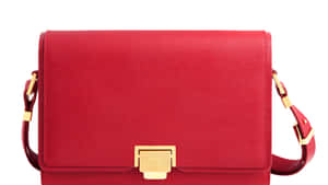 Classy Red Handbag On A Wooden Table Wallpaper