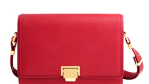 Classy Red Handbag On A Wooden Table Wallpaper