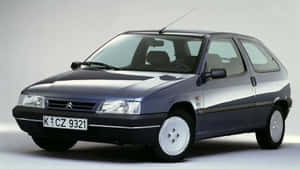 Classy White Citroen Zx Parked On The Road Wallpaper