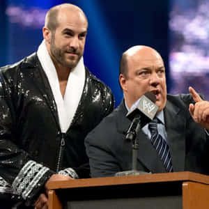 Claudio Castagnoli In Shiny Robe With Paul Heyman Wallpaper
