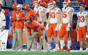 Clemson Tigers Football Team And Coaching Staff Wallpaper