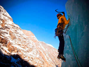 Climber Ascending A Frozen Waterfall Wallpaper