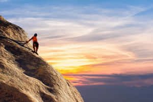 Climber Ascending Mountain Dusk.jpg Wallpaper