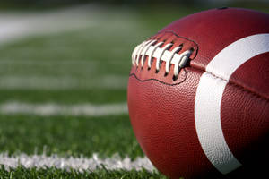 Close-up Cool Football On Grass Wallpaper