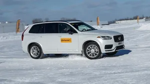 Close-up Of Winter Tires On A Snowy Road Wallpaper