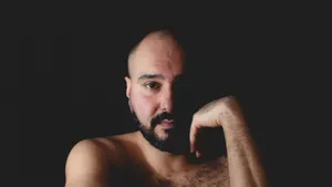 Close-up Portrait Of A Bald Man With A Full Black Beard Wallpaper