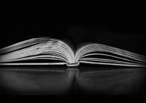 Close-up Shot Of An Open Book In Black And White Wallpaper