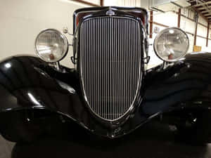 Close-up View Of A Car Grill On A Sleek, Modern Vehicle Wallpaper