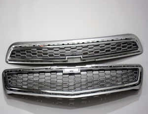 Close-up View Of A Shiny Car Grill On A Modern Vehicle Wallpaper