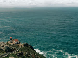 Coastal_ Lighthouse_ Overlooking_ Ocean Wallpaper