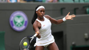 Coco Gauff Striking The Tennis Ball Wallpaper