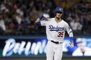 Cody Bellinger Flexing In Field Wallpaper