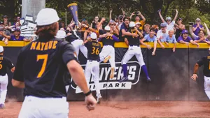 College Baseball Players In Action On The Field Wallpaper