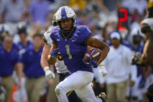 College Football Player Running With Ball Wallpaper