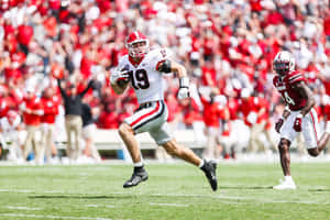 College Football Player Running With Ball Wallpaper