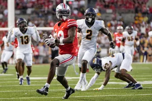 College Football Receiver Catch Action Wallpaper