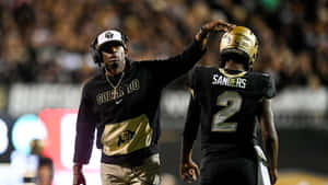 Colorado Buffaloes Coachand Player Moment Wallpaper