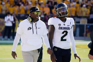 Colorado Football Coachand Player Walking Wallpaper