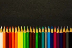 Colored Sharp Pencils Against Black Surface Wallpaper