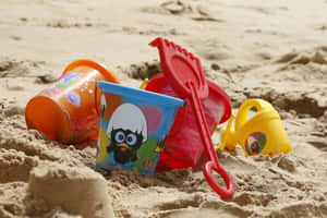Colorful Beach Toys On The Sand Wallpaper