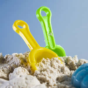 Colorful Beach Toys On The Seashore Wallpaper