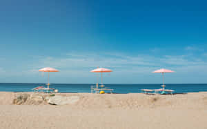 Colorful Beach Umbrella On A Sunny Day Wallpaper