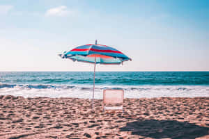 Colorful Beach Umbrella On A Sunny Day Wallpaper