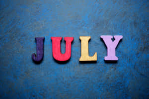 Colorful July Letterson Blue Background Wallpaper