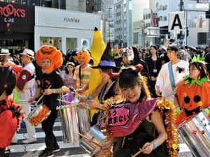 Colorful Marching Bands Light Up The Night During A Halloween Parade. Wallpaper