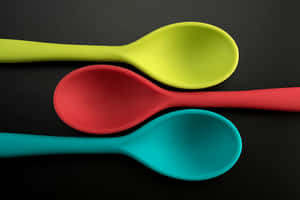 Colorful Plastic Spoons Black Background Wallpaper