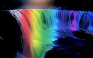 Colorful Rainbow Falls In The Midst Of A Serene Forest Wallpaper