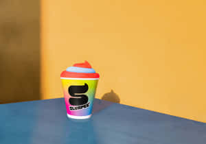 Colorful Slurpee Cup Against Yellow Background Wallpaper