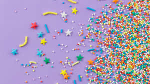 Colorful Sprinkleson Purple Background Wallpaper