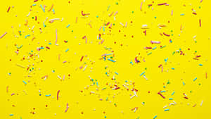 Colorful Sprinkleson Yellow Background Wallpaper