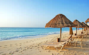 Colorful Striped Beach Umbrella On A Sunny Day Wallpaper