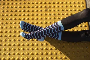 Colorful Striped Sockson Yellow Textured Surface Wallpaper