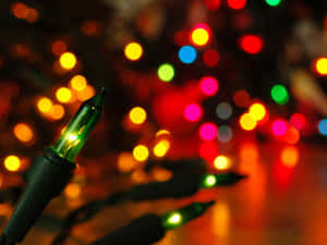 Colouring In The Dark Winter Sky, An Illuminated Christmas Night Creates A Peaceful And Magical Ambiance. Wallpaper