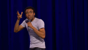 Comedian Performingon Stage Wallpaper