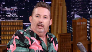 Comedianin Flamingo Shirt During Interview Wallpaper