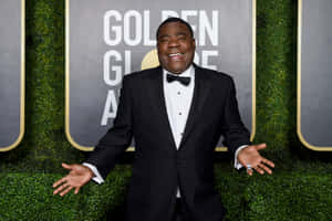 Comedy Icon Tracy Morgan Spotlighted Against A Dark Backdrop Wallpaper