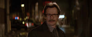 Commissioner James Gordon Standing Proudly In The Gritty City Of Gotham Wallpaper