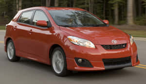 Compact Car Parked On A City Street Wallpaper