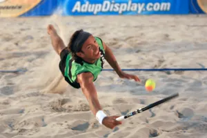 Competitive Beach Tennis Action Wallpaper