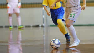 Competitive Indoor Soccer Action Wallpaper