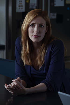 Concerned Womanin Dark Room Wallpaper