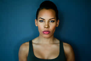 Confident Woman Blue Backdrop Wallpaper