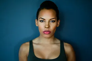 Confident Woman Blue Backdrop Wallpaper