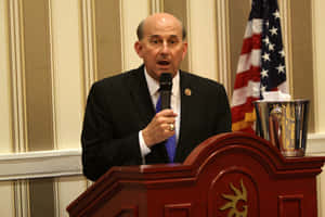 Congressman Louie Gohmert Passionately Speaking Into A Microphone Wallpaper